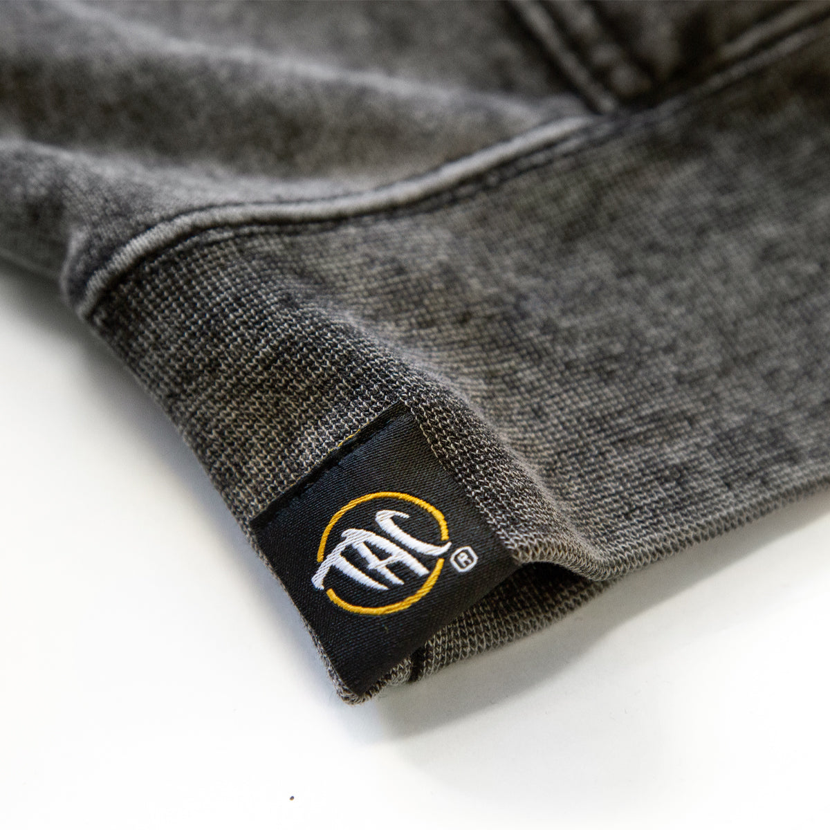 Pineapple Mineral Wash Hoodie — TAC hem label detail